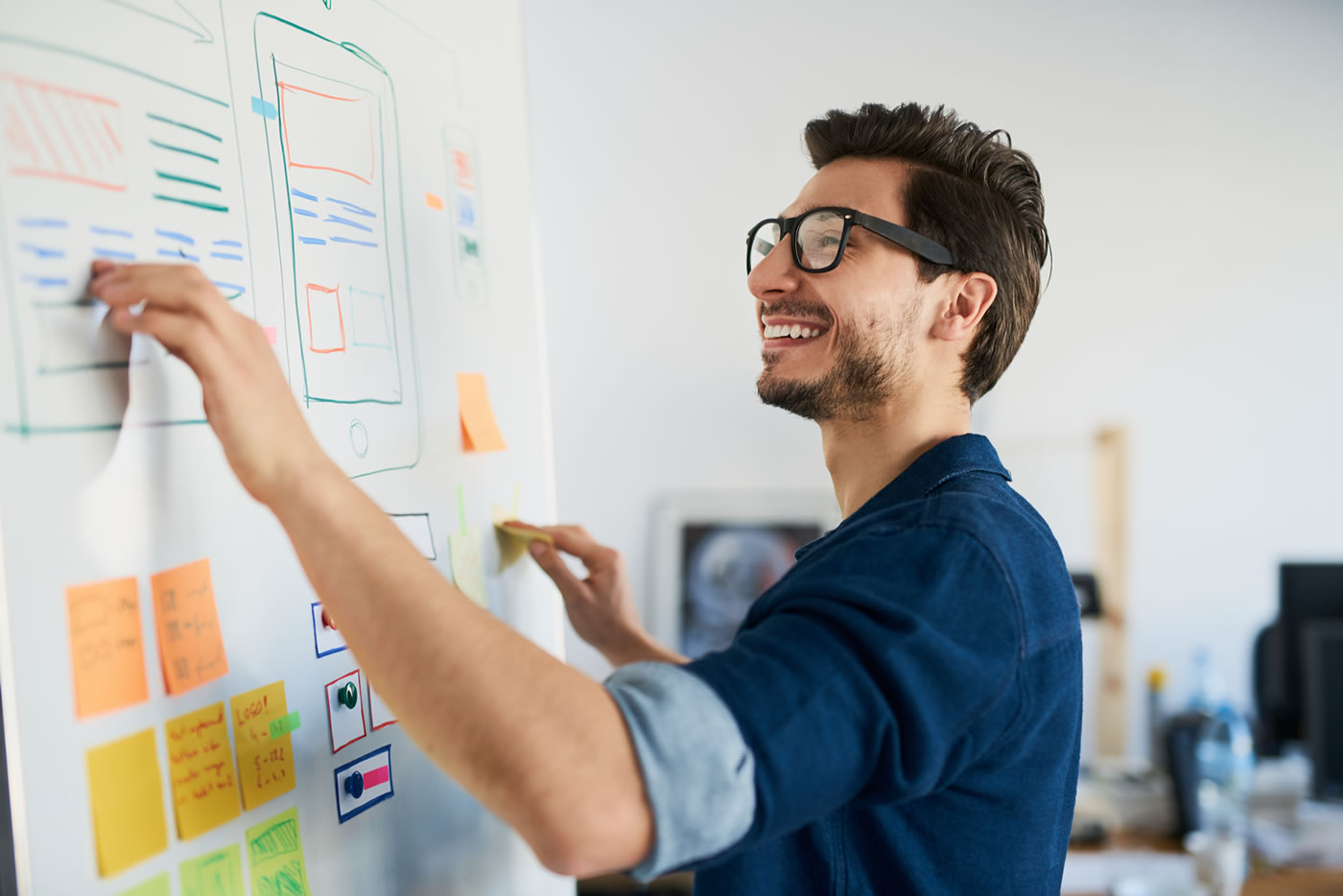 Man writing on Agency whiteboard
