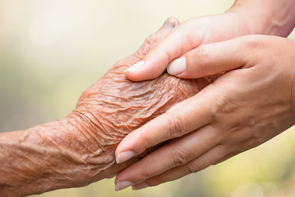 Young Person holding old person's hand