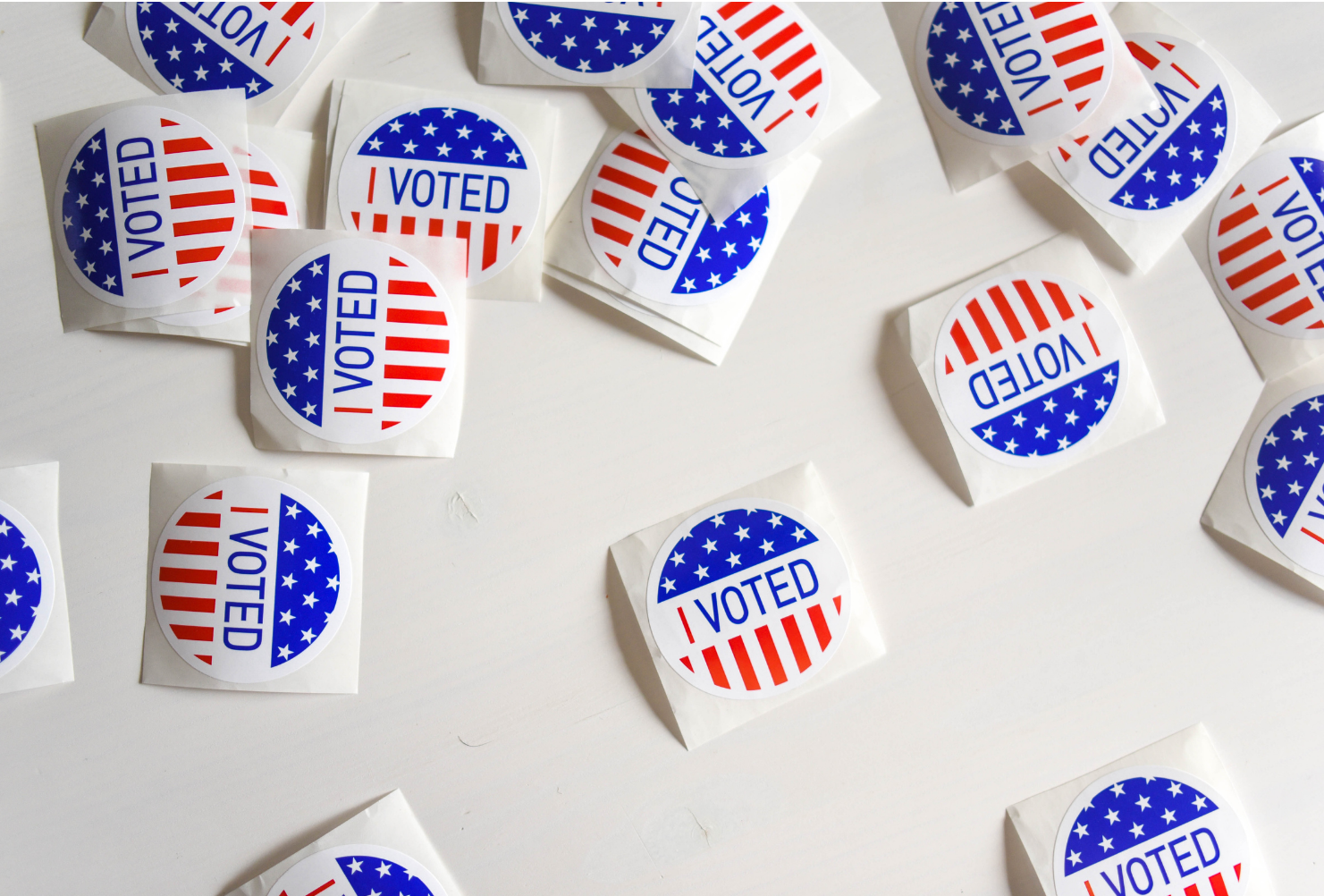 Voting stickers scattered on a white background