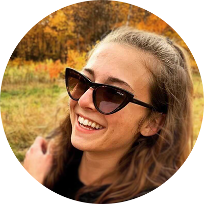 Smiling woman with long brown hair and sunglasses