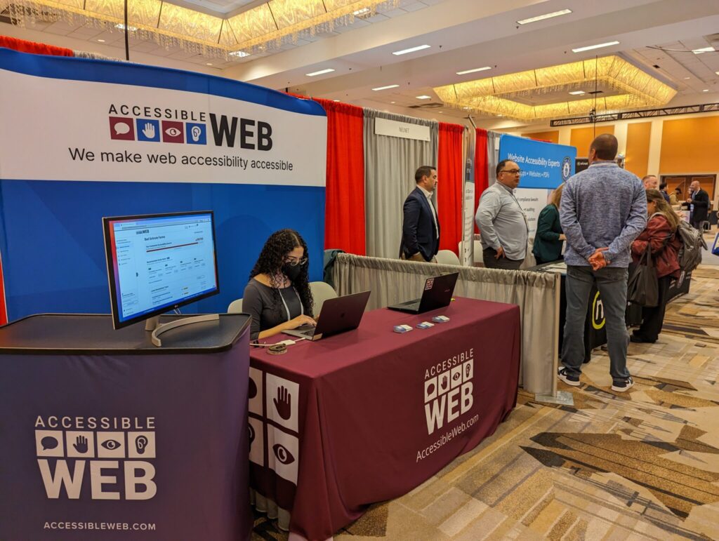 Liz sitting at the Accessible Web booth.