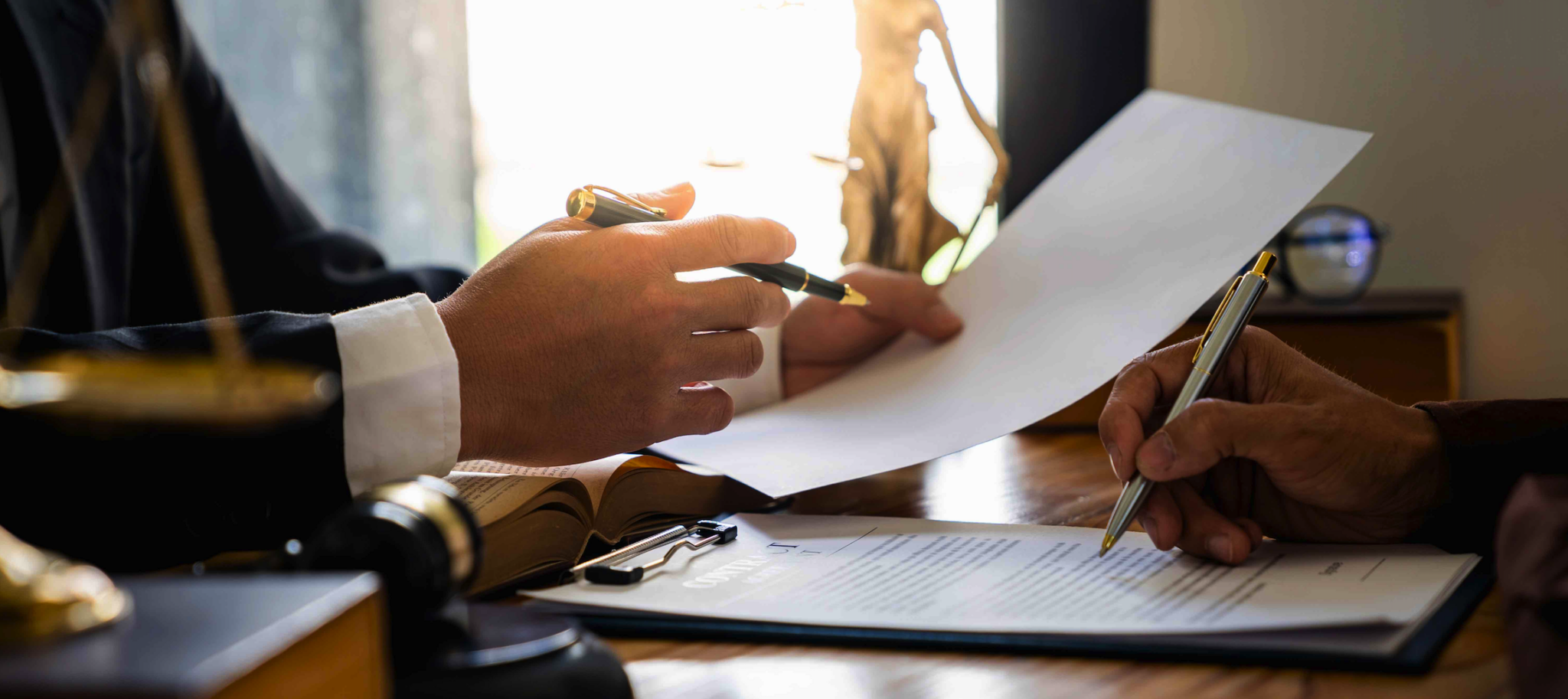 two lawyers reviewing legal paperwork at a desk