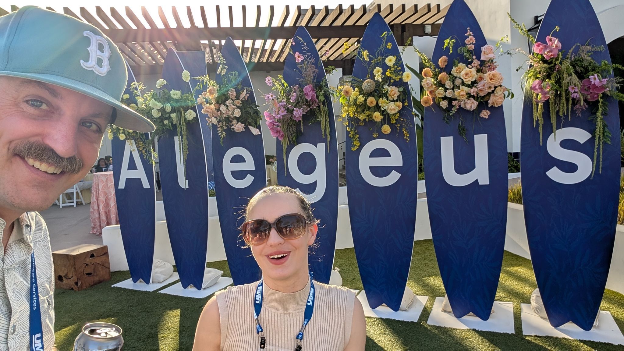Peter Jewett and Gianna Barnhart standing in front of Alegeus conference sign in Carlsbad, California.